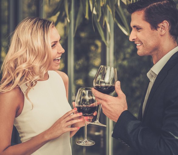 Couple with glasses of red wine in restaurant