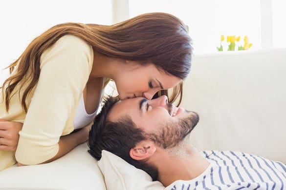 Cute couple relaxing on couch at home in the living room