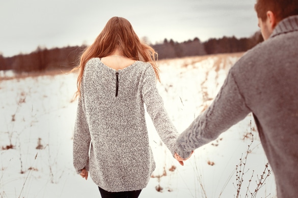 Happy Young Couple in Winter Park having fun