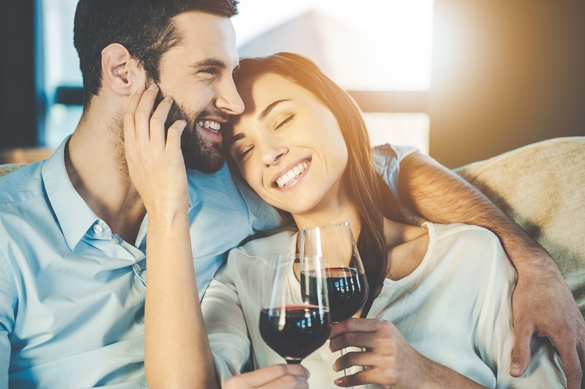 beautiful-young-loving-couple-sitting-close-to-each-other-and-drinking-red-wine