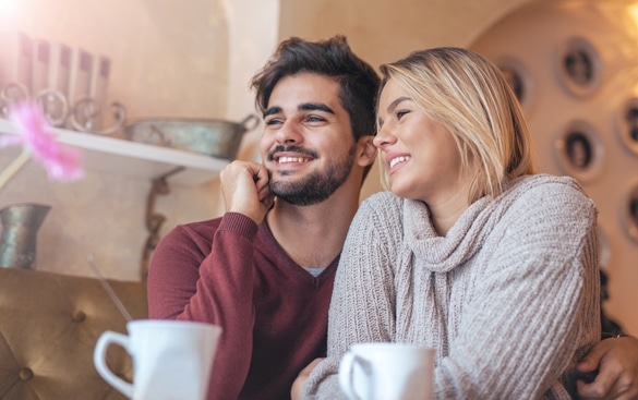 Beautiful young couple sitting in a cafe - What Does A Taurus Man Like About A Pisces Woman