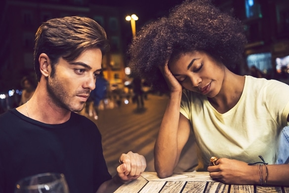 Casual interracial couple having an argument in a terrace - Taurus Man and Aquarius Woman Breakup