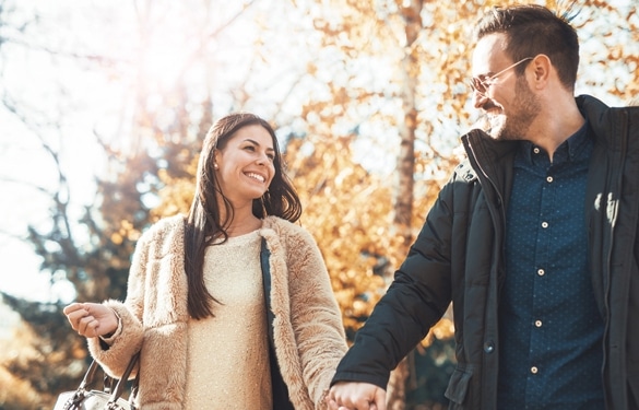 Young embracing loving couple walking through autumn park - How To Seduce A Taurus Man With Words