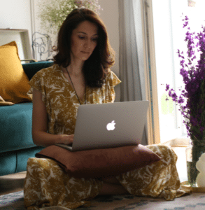 anna kovach astrologer doing natal chart on her computer